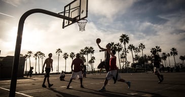 A game of people playing basketball
