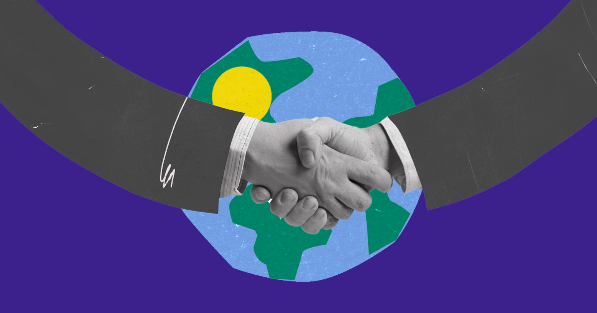 A handshake over a globe on a purple background.