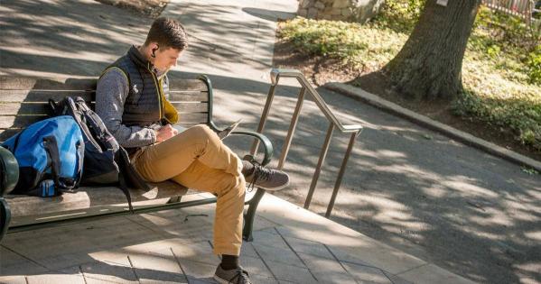 Student sitting on a bench outside Kogod