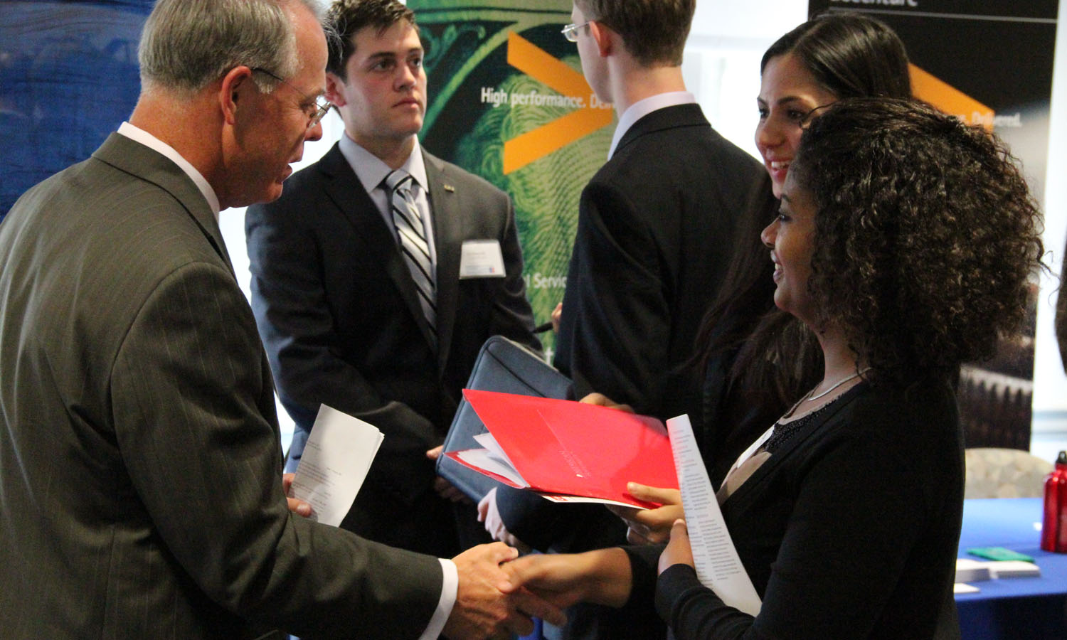 Student shaking hands with a recruiter at a job fair