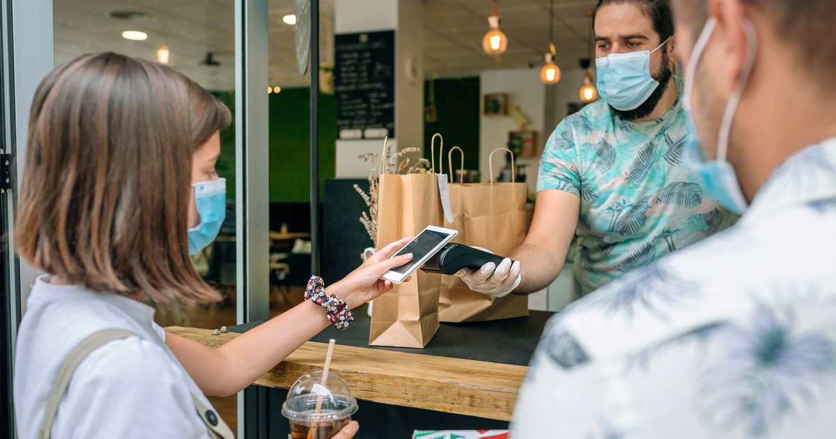 A shopper making a purchase outside of a store